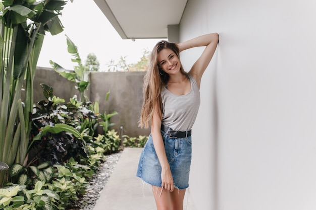 Short denim skirts let the shirt drop over like a soft shield with boots up to your knees.