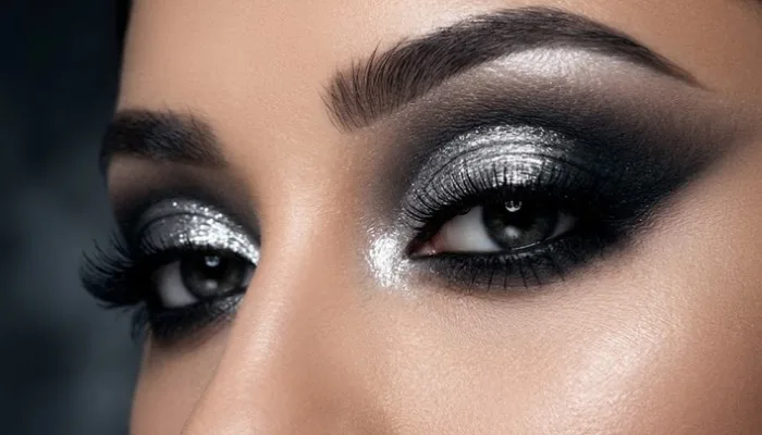 Dramatic silver and black smokey eyeshadow blend with liquid silver accent on the lid